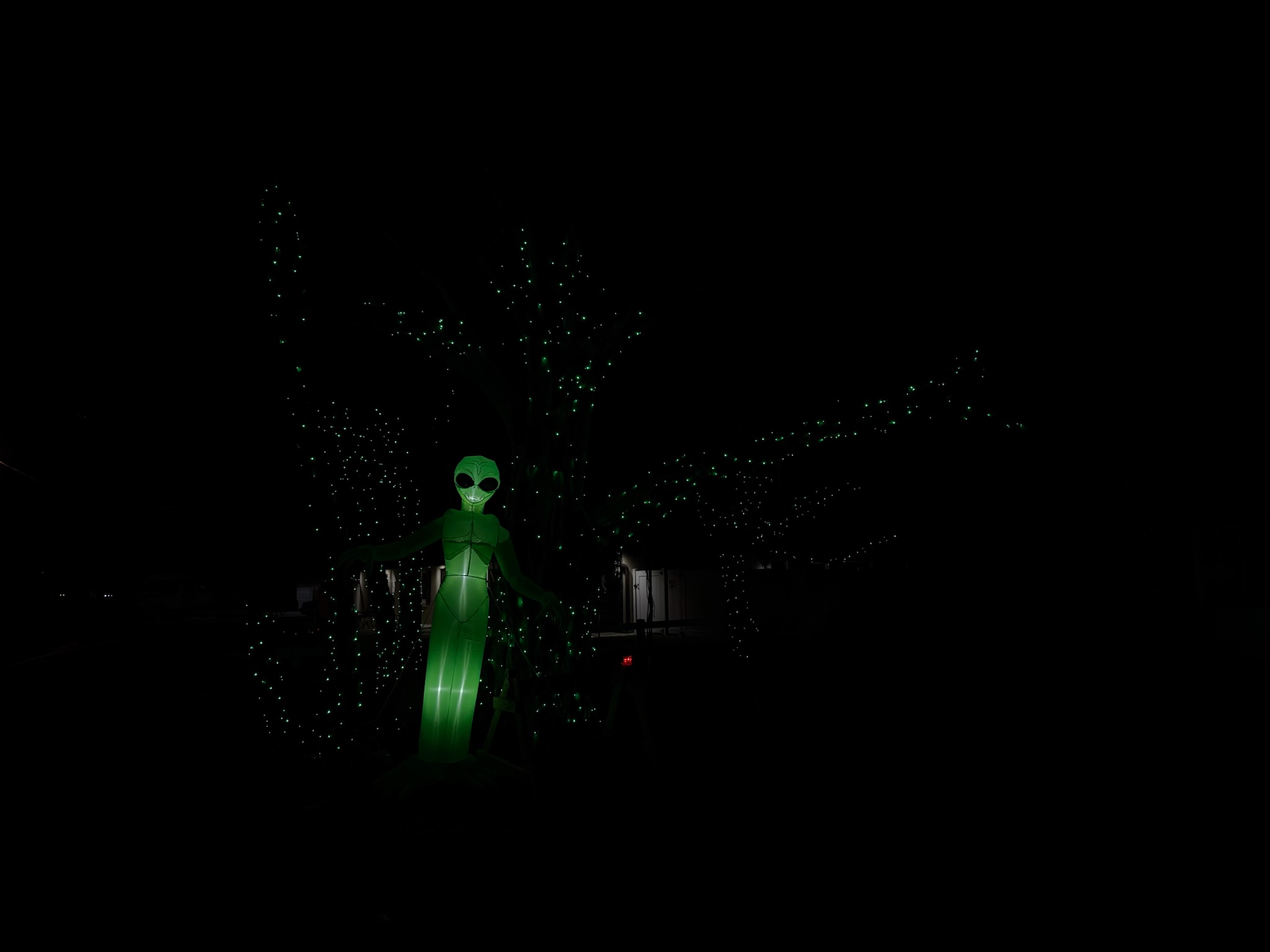 An elegant home with subtle, warm lighting highlighting its architectural features for the holidays.